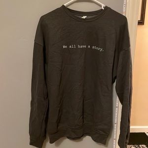 "We all have a story." crewneck